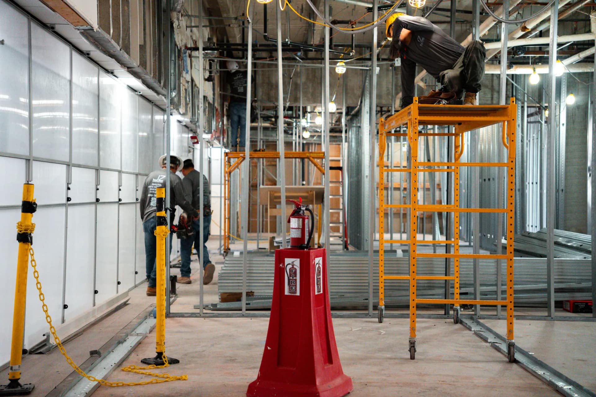 JZ construction crew working from scaffolds within metal framing at Bascom Palmer