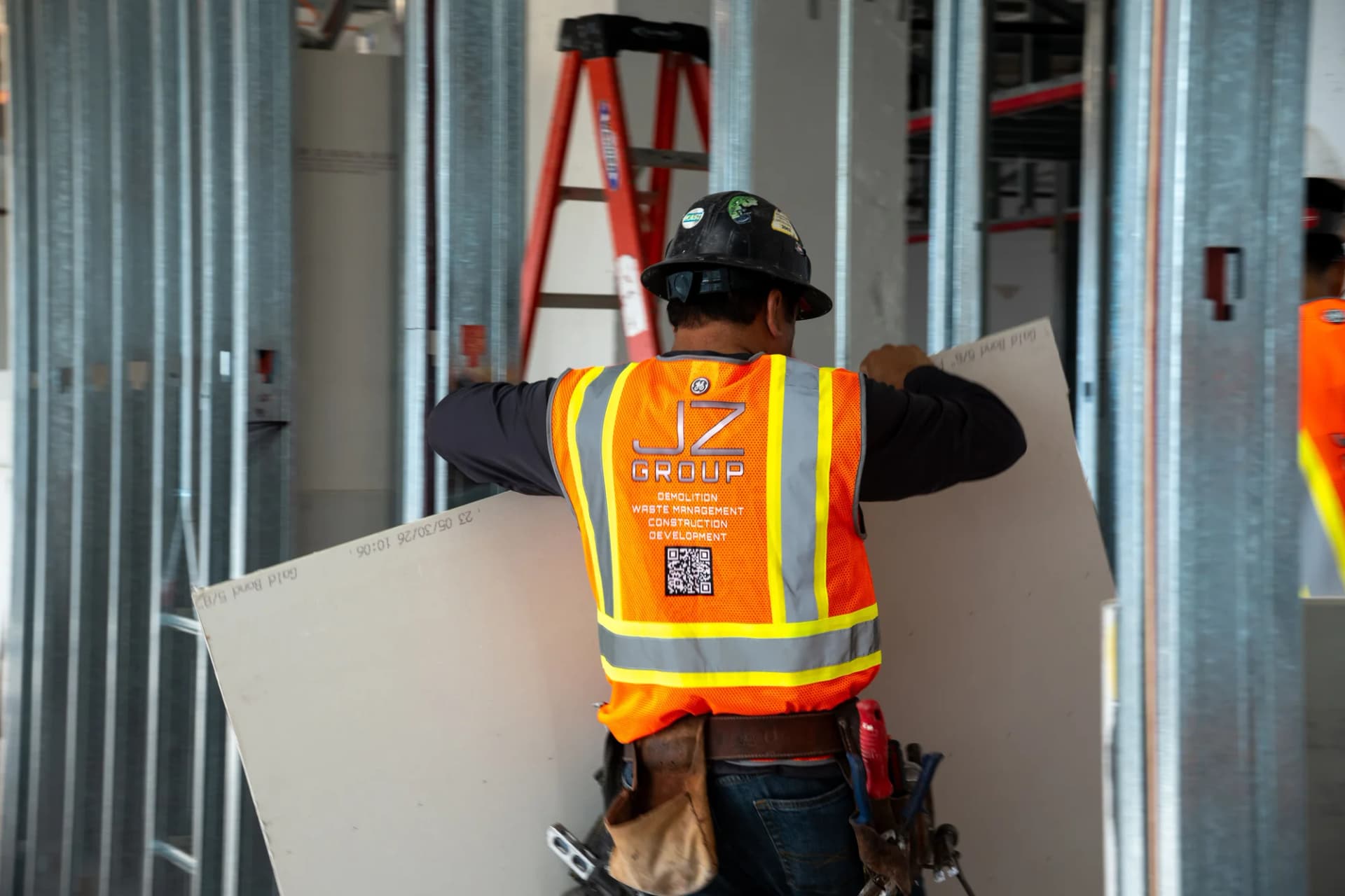 JZ crew member fitting drywall at 100 Biscayne