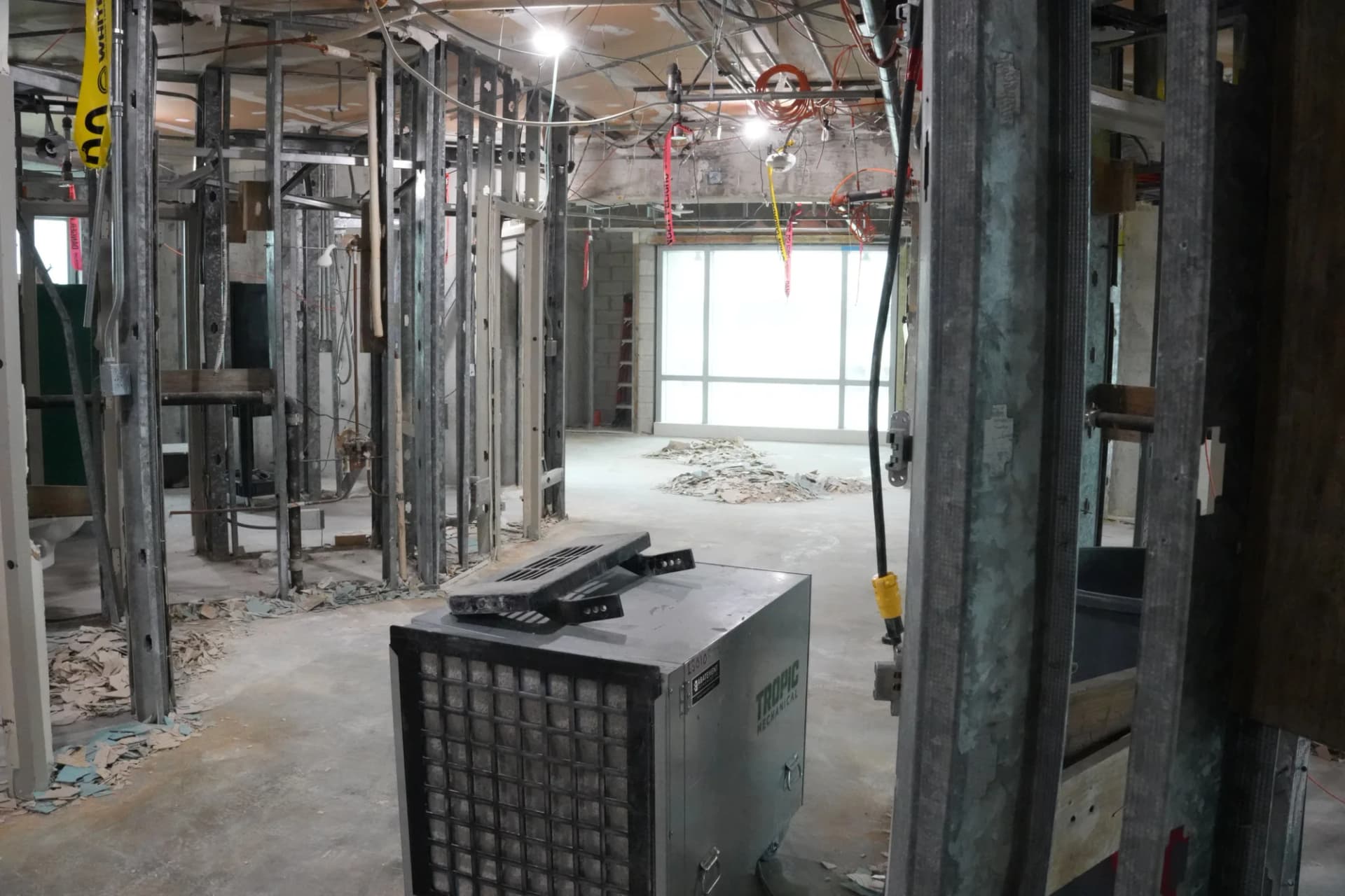 Portable air-control equipment in a framed work corridor at the UHealth Tower penthouse
